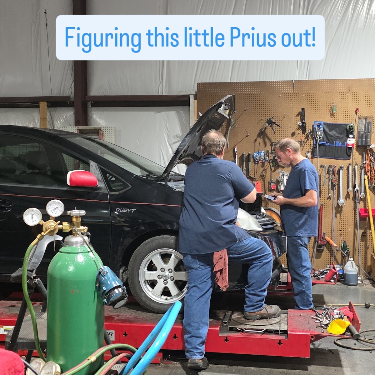 Mechanics working on a Prius